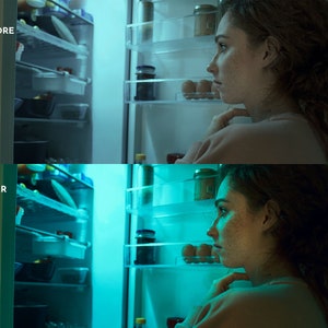 May include: A woman stands in front of a refrigerator with the door open. The refrigerator is lit with a bright blue light. The woman is looking into the refrigerator with a thoughtful expression on her face.