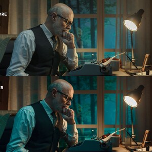 May include: A man sits at a desk in a dimly lit room, typing on a vintage typewriter. He is wearing a vest and a white shirt, and has a thoughtful expression on his face. A lamp with a white shade illuminates the desk, casting a warm glow on the scene.