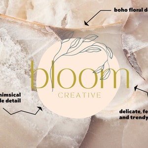 May include: A logo design with the word "bloom" in a delicate, feminine font, and the word "creative" below. It features a whimsical circle detail and a boho floral element, set against a light beige background.