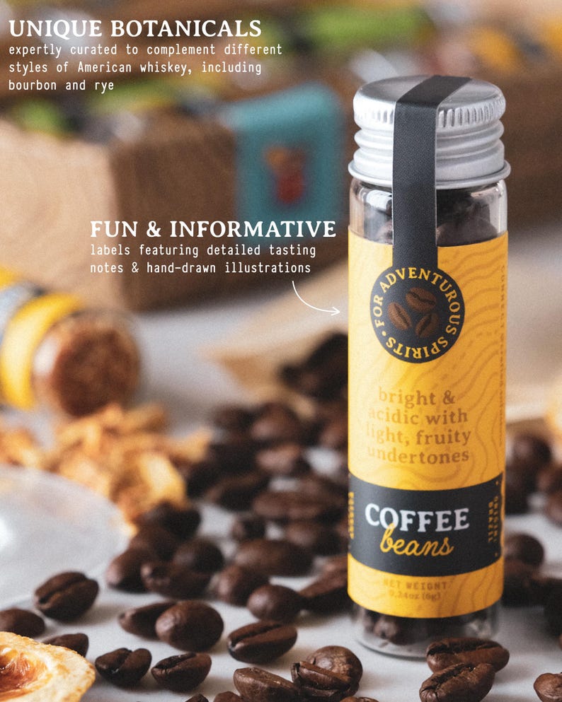 May include: A small glass bottle filled with coffee beans, featuring a yellow label with the text "COFFEE beans". The label also includes the text "bright & acidic with light, fruity undertones". The bottle is surrounded by coffee beans.