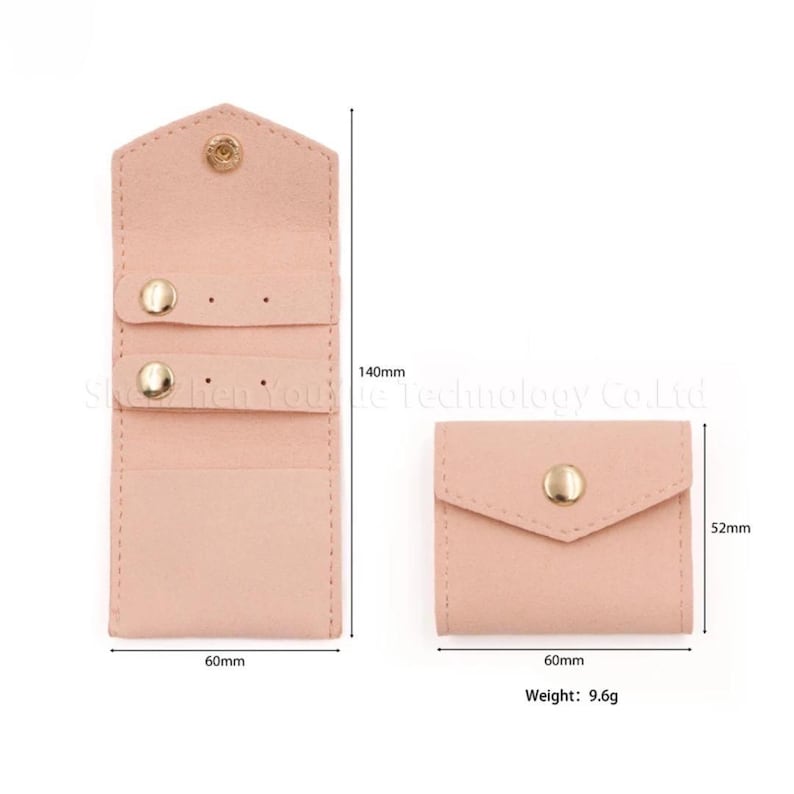 May include: A light pink, suede-like jewelry organizer with a snap closure. The open organizer is 140mm tall and 60mm wide, with two rows for earrings. A smaller, closed pouch is also shown, 52mm tall and 60mm wide. Weight: 9.6g.