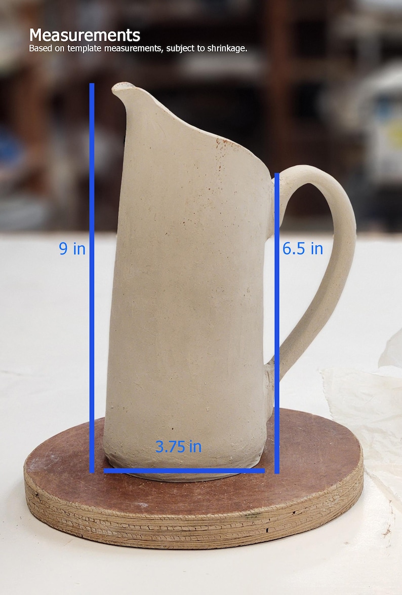 May include: A handmade, off-white ceramic pitcher with a curved handle. The pitcher is 9 inches tall, 6.5 inches wide, and 3.75 inches in diameter. The pitcher is sitting on a round, brown surface. The text "Measurements" is visible.