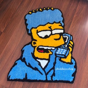 May include: A handmade rug depicting a cartoon character with blue hair and a yellow face, holding a blue phone. The rug has a blue outline and a white shirt. The text "chickbosssshop" is visible on the rug.