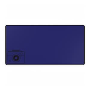 May include: A rectangular navy blue desk mat with a black border. A black line drawing of a camera is in the lower left corner. The text above the camera is blurry.
