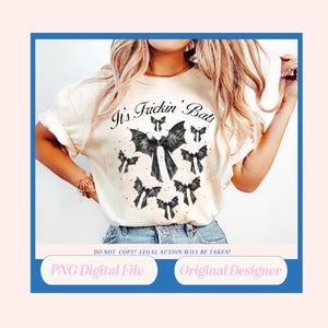 May include: A white t-shirt with the text "It's Frickin' Bats" and a black and white graphic of bats with bows. The text "DO NOT COPY! LEGAL ACTION WILL BE TAKEN!" is below the graphic. The shirt is being worn by a person.