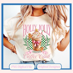 May include: A white t-shirt with a pink and green design featuring a gingerbread man, a cup of coffee with whipped cream and a candy cane, and the text "Holly Jolly Christmas Coffee Club".
