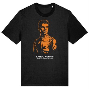 May include: Dark grey t-shirt with an orange silhouette of a person in a racing suit. The text "LANDO NORRIS WORLD CHAMPION 2025" is printed below the image. The shirt has a black collar and sleeves.