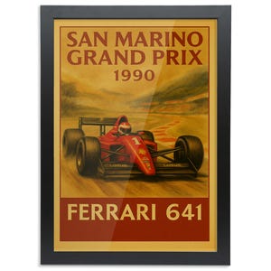 May include: Framed poster of a red Ferrari 641 race car from the 1990 San Marino Grand Prix. The poster is in a black frame, with text at the top and bottom, and a vintage aesthetic.