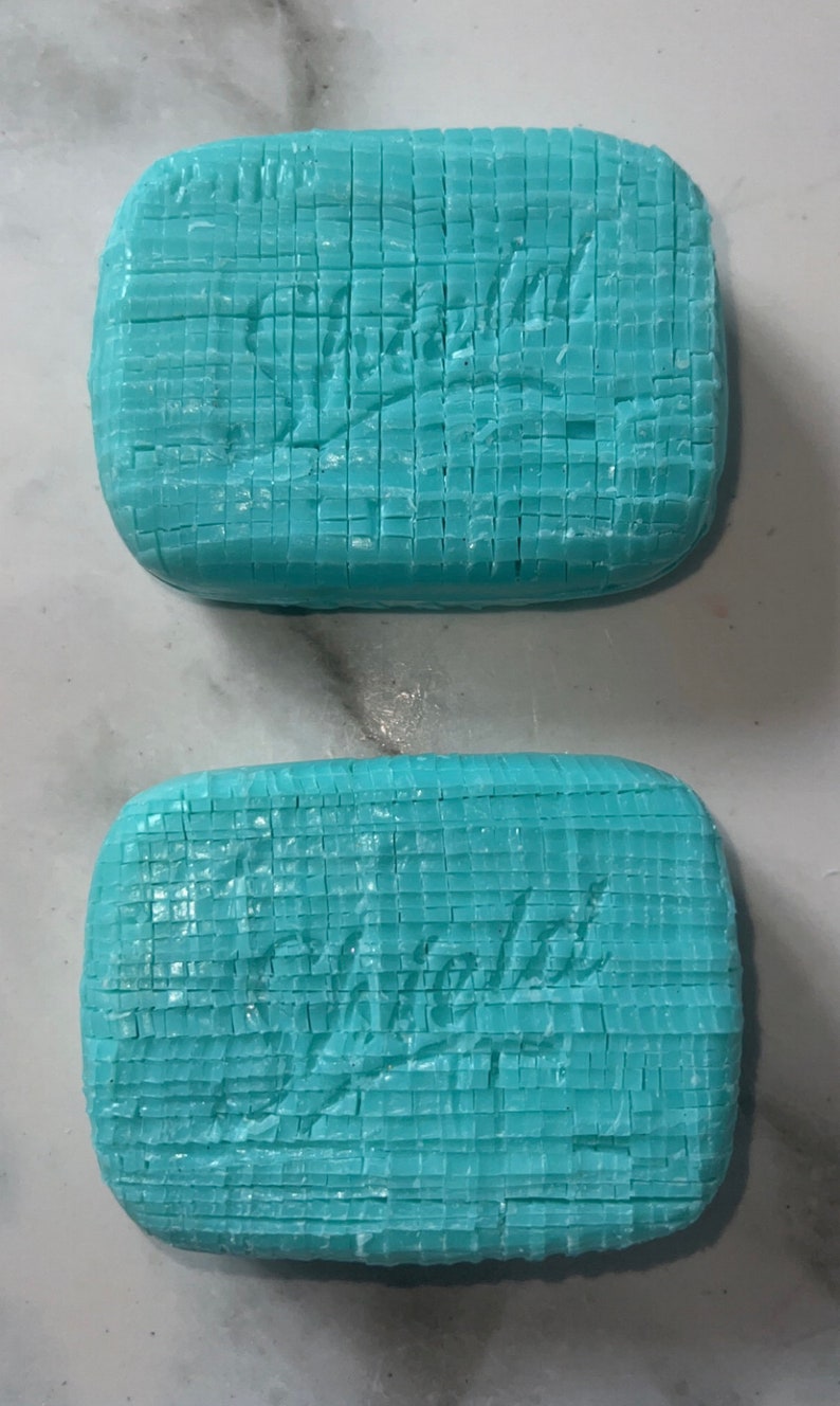 May include: Two bars of light blue soap with the word "Violets" embossed on each bar.