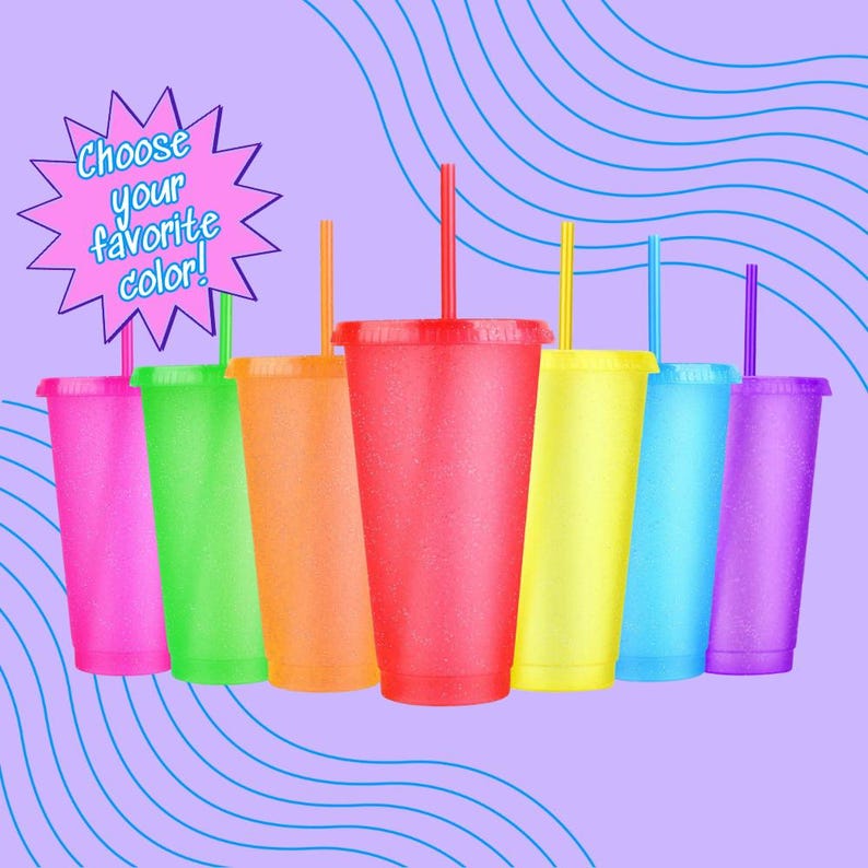A collection of colorful plastic cups with straws, arranged in a row against a purple background with wavy lines.