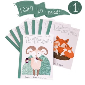 May include: A stack of children's books with the title "Ram Has Jam" and illustrations of a ram and foxes. The books are level 1 and feature the text "Learn to read!" on a green banner. A green circle with the number 1 is also visible.