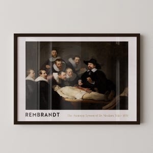 May include: Framed print of Rembrandt's "The Anatomy Lesson of Dr. Nicolaes Tulp - 1632." The artwork depicts a group of men observing a dissection. The print is in a dark brown frame, with the artist's name and title at the bottom.