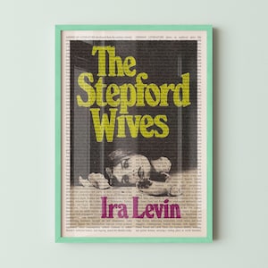 May include: A framed poster with a mint green border. The poster features the title "The Stepford Wives" in yellow, with the author's name, "Ira Levin," in pink. The background is a collage of text and a grayscale image.