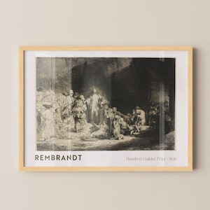 May include: A framed black and white print of Rembrandt's "Hundred Guilder Print - 1649". The artwork depicts a religious scene with figures gathered around a central figure radiating light. The print is in a light wood frame.