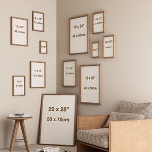 May include: A collection of framed art prints in various sizes, including 8x10 inches, 16x20 inches, and 20x28 inches. The frames are a warm brown color, and the prints have white backgrounds. The sizes are displayed in inches and centimeters.