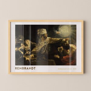 May include: A framed print of Rembrandt's "Belshazzar's Feast - 1635". The artwork depicts a dramatic scene with figures in ornate clothing, illuminated by a glowing inscription. The artist's name is printed at the bottom left.