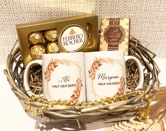 May include: A wicker basket filled with a gift set including two white mugs with floral designs and the text "Ali Half Her Deen" and "Maryam Half His Deen", a box of Ferrero Rocher chocolates, and a bottle of perfume.
