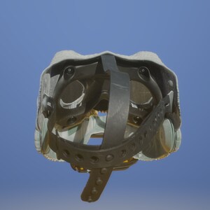 May include: A gray and black helmet with a strap and adjustable buckles. The helmet has a padded interior and a hard outer shell.