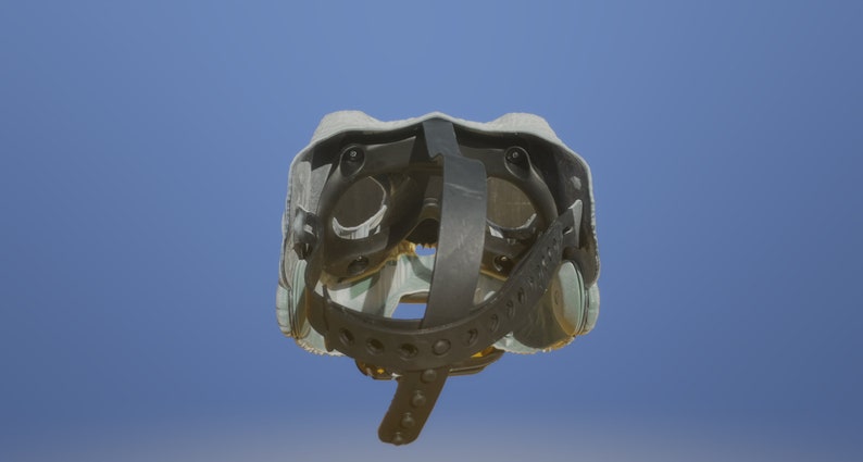 May include: A gray and black helmet with a strap and adjustable buckles. The helmet has a padded interior and a hard outer shell.