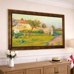 May include: A rectangular landscape painting in a dark ornate gold frame featuring an impressionist scene of a stone wall, a central tree, and a dirt path in shades of green, yellow, and blue, displayed horizontally on a light-colored wall.