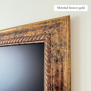 May include: Close-up of a rectangular frame with a mottled brown-gold finish. The frame has a decorative rope-like inner border and a gold outer edge. The text "Mottled brown-gold" is in the upper right corner.