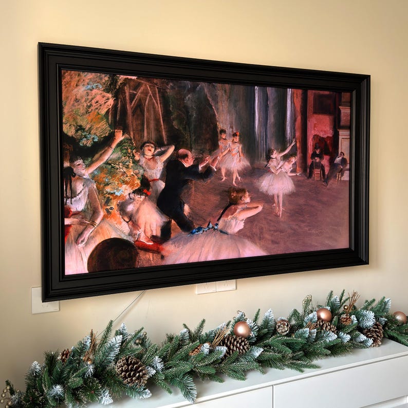 May include: A framed painting depicting a ballet performance with dancers in white tutus and a man in a black suit. The painting is set in a theater with a stage and audience. The dancers are in mid-air, performing a graceful dance.