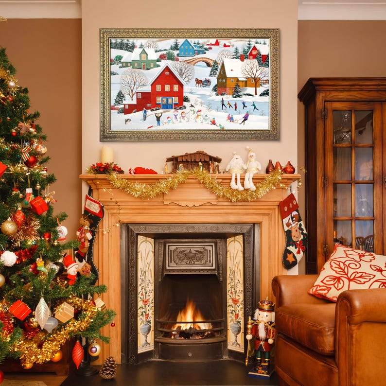 May include: A decorated Christmas tree stands to the left of a fireplace with a framed winter scene painting above it. The painting depicts a snowy village with red and green houses, and people playing in the snow. A leather armchair sits to the right.