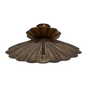 May include: A dark bronze ceiling light fixture featuring a tiered design with two shell-shaped, scalloped metal shades. The larger lower shade is wide and circular, while the smaller upper shade is positioned centrally above it.