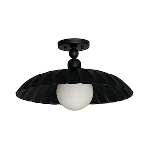May include: A black ceiling light fixture with a scalloped shade and a white globe light. The fixture has a round base and a series of spherical accents. The shade has a textured, ridged design.