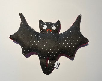 Lavender creatures bat shape black with white dots