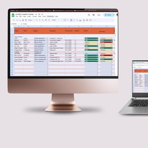 May include: A desktop computer and a laptop display a spreadsheet titled "Content Creation Tracker." The spreadsheet has orange and green highlighted cells, with rows of data. The desktop computer is rose gold, and the laptop is silver.