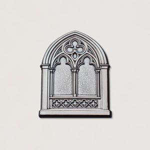 May include: A silver-colored, gothic-style window ornament. The arched window features two vertical panels, a decorative top, and a lower section with repeating cross-like designs. The ornament has a black base and is set against a white background.