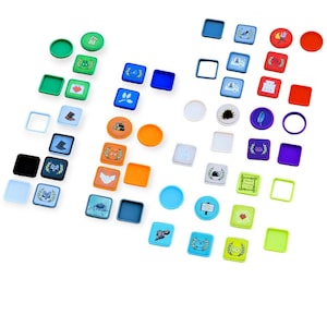 May include: A collection of colourful game pieces with various designs, including animals, symbols, and text. The pieces are made of plastic and have a variety of shapes, including circles, squares, and rectangles.