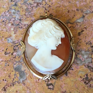 Genuine Shell Carved Pretty Lady Cameo Pendant / Brooch Pin. Very Detailed. Shell Cameo is in Excellent Condition. Frame Shows Wear & Age.