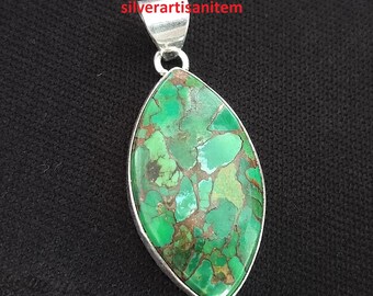 May include: A silver pendant with a green turquoise stone. The stone has a marbled pattern with brown and green hues.
