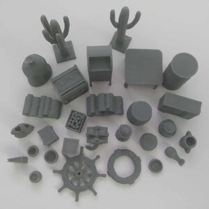 May include: A collection of 3D printed miniature objects, including a cactus, a ship's wheel, a barrel, a chest, a building, and a variety of other items. The objects are all grey and appear to be made of plastic.