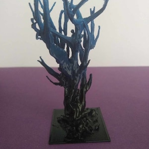 May include: A 3D printed tree model with a dark blue and black colour scheme. The tree has a thick trunk and many branches that reach upwards.