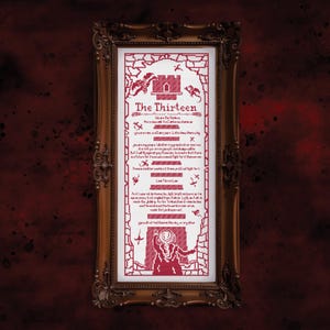 May include: A framed cross-stitch artwork with a gothic theme. The red and white design features the text "The Thirteen" and other text, along with illustrations of a castle, bats, and a cloaked figure. The frame is ornate and brown.
