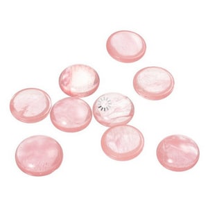 May include: A collection of eight smooth, round, pink rose quartz stones. The stones are all approximately the same size and shape.