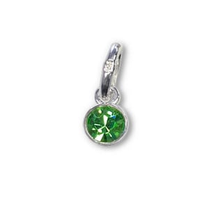May include: A small, round, green gemstone charm with a silver-colored bail. The gemstone is faceted, reflecting light. The charm is designed to be attached to a bracelet or necklace.