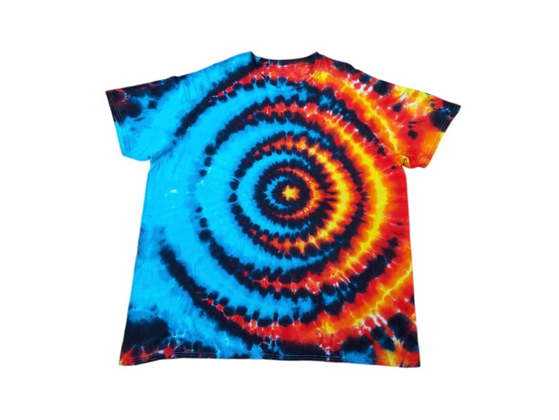 May include: A tie-dye t-shirt with a blue, black, orange and yellow spiral design.