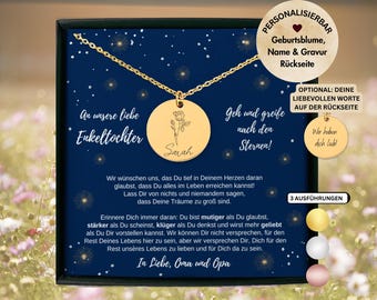 May include: A gold-toned circular pendant necklace featuring a rose engraving and the name Sarah, presented on a dark blue card with German text. The card includes star motifs and a circular insert showing an optional engraved back message.