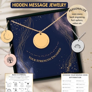 May include: Gold and silver-toned necklaces with round pendants are displayed in a gift box. The pendants feature engraved designs and can be personalized with symbols or Morse code affirmations. The box has the text "HIDDEN MESSAGE JEWELRY".