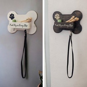 May include: Two dog bone shaped wall organizers, one white and one dark brown, with a leash hook, a small shelf, and the text "Find Joy in Every Step".