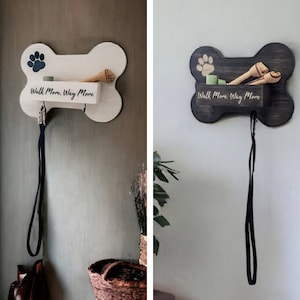 May include: White and black wooden dog bone shaped wall hooks with the text "Walk More, Wag More" and a paw print design. Each hook has a black leash attached.