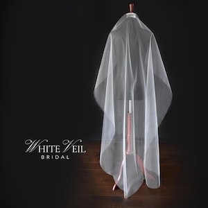 May include: A sheer white veil draped over a mannequin, featuring a smooth, flowing fabric texture. The text "WHITE VEIL BRIDAL" is printed in a white, elegant serif font on the left side of the image against a dark, solid background.