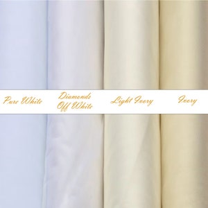 May include: Four vertical fabric rolls displayed side-by-side in varying shades of white and cream. A horizontal white band across the center features the gold text labels: Pure White, Diamonds Off White, Light Ivory, and Ivory.