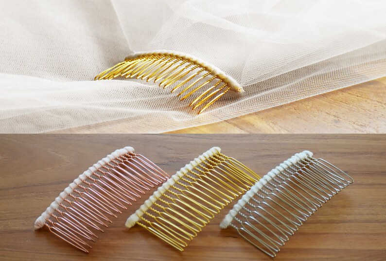 May include: A gold-toned hair comb attached to a sheer white veil, alongside three additional hair combs in rose gold, gold, and silver tones. Each comb features a row of thin metal teeth and a white fabric-wrapped top edge for secure placement.