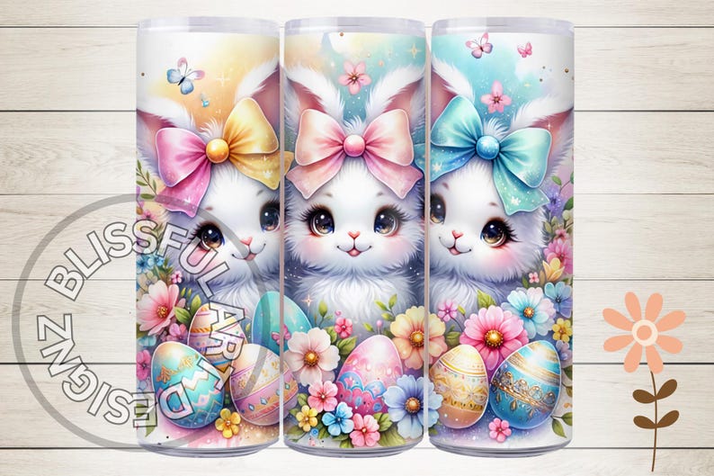 May include: Three 20 oz. stainless steel tumblers with a spring-themed design. Each tumbler features a cute bunny with a bow and pastel-colored Easter eggs. The tumblers are surrounded by colorful flowers.