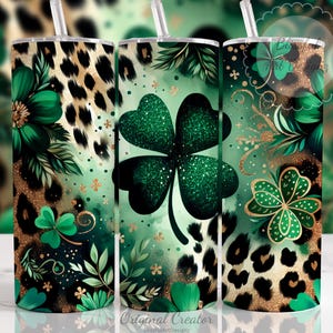 May include: Three stainless steel tumblers with St. Patrick's Day designs. The tumblers feature a green and gold color scheme with leopard print, shamrocks, and floral accents. Each tumbler has a straw.